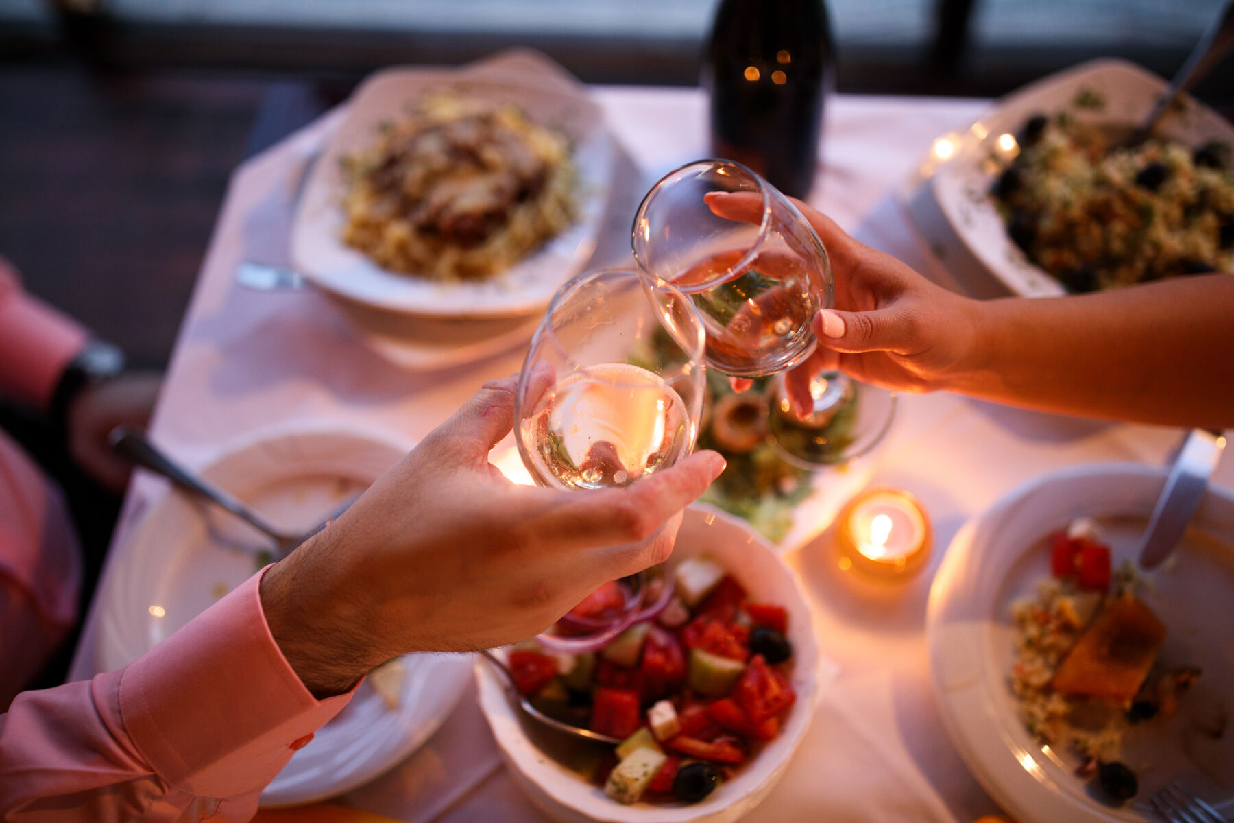Couple Toasting With Wine at Dinner - Date Night