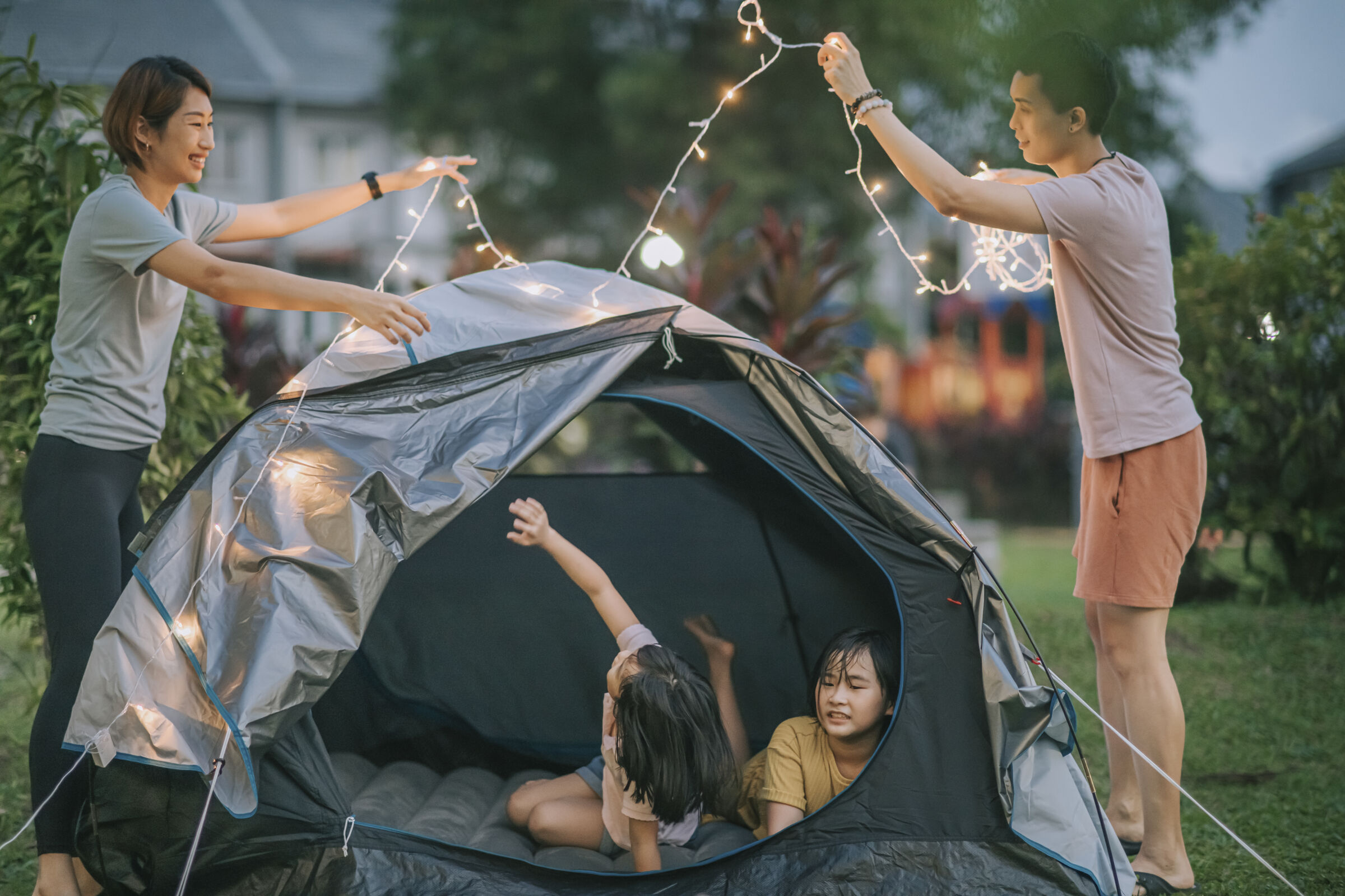 Family Setting Up Tent in Backyard