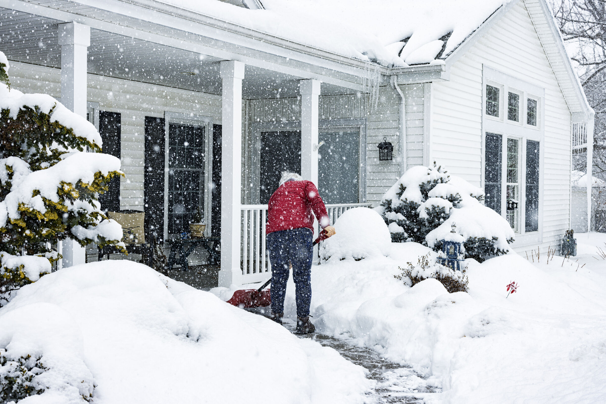 Person Shoveling Sidewalk in Winter