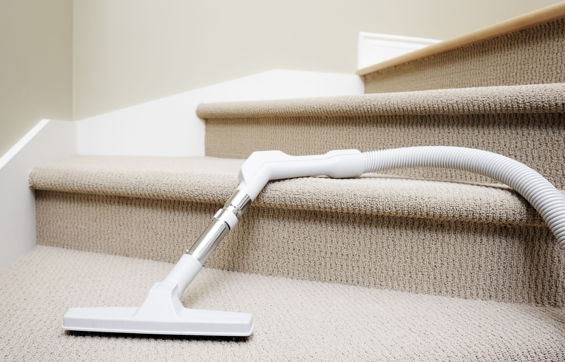 Vacuum cleaner on carpeted stairs