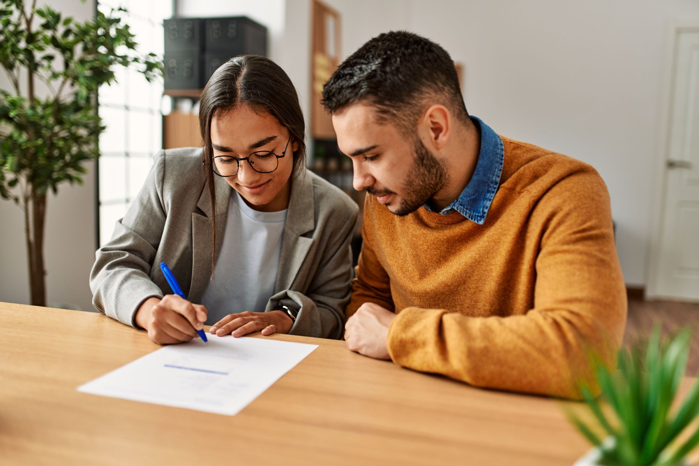 Young couple signing a contract