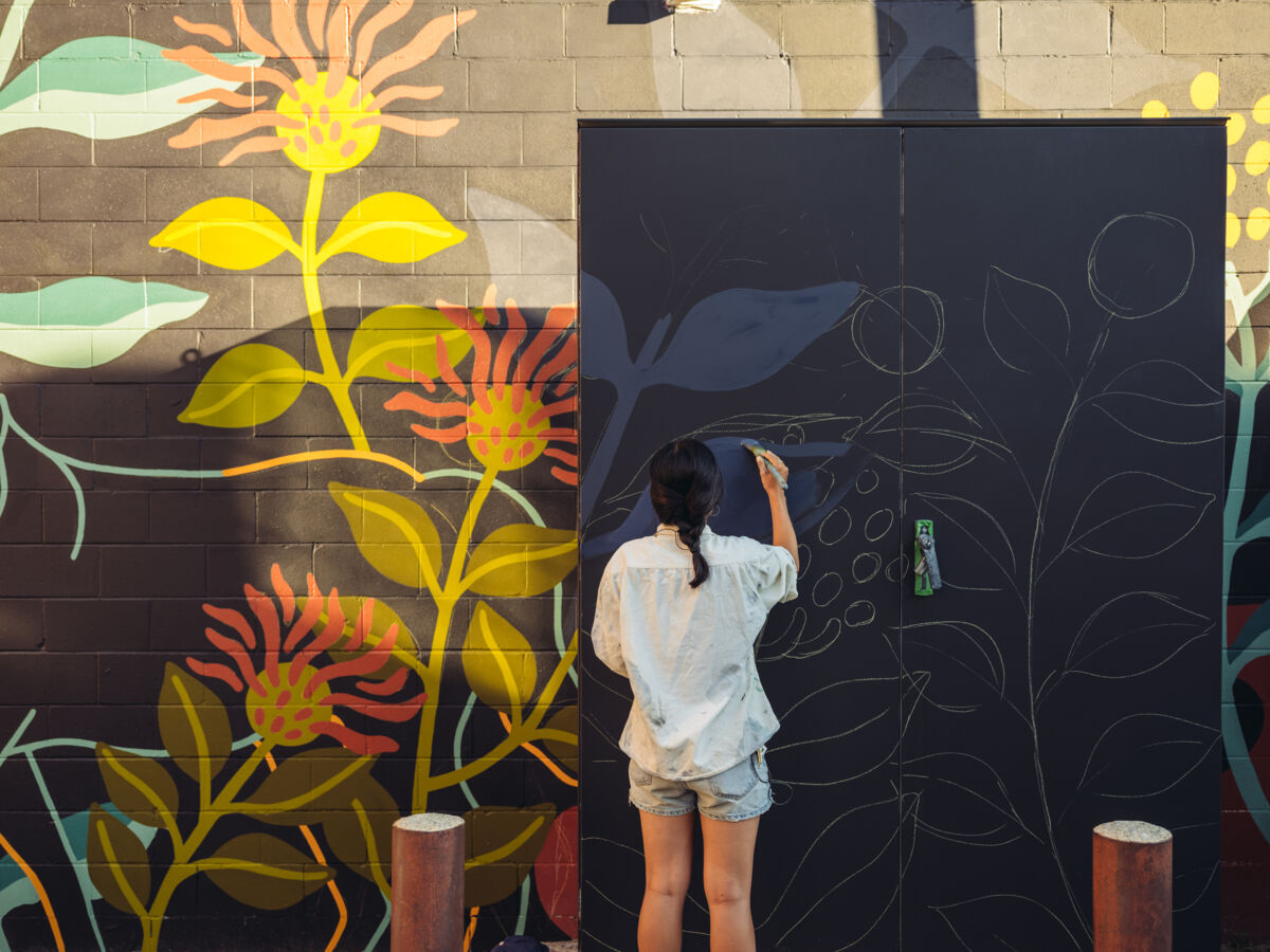 Woman painting a mural